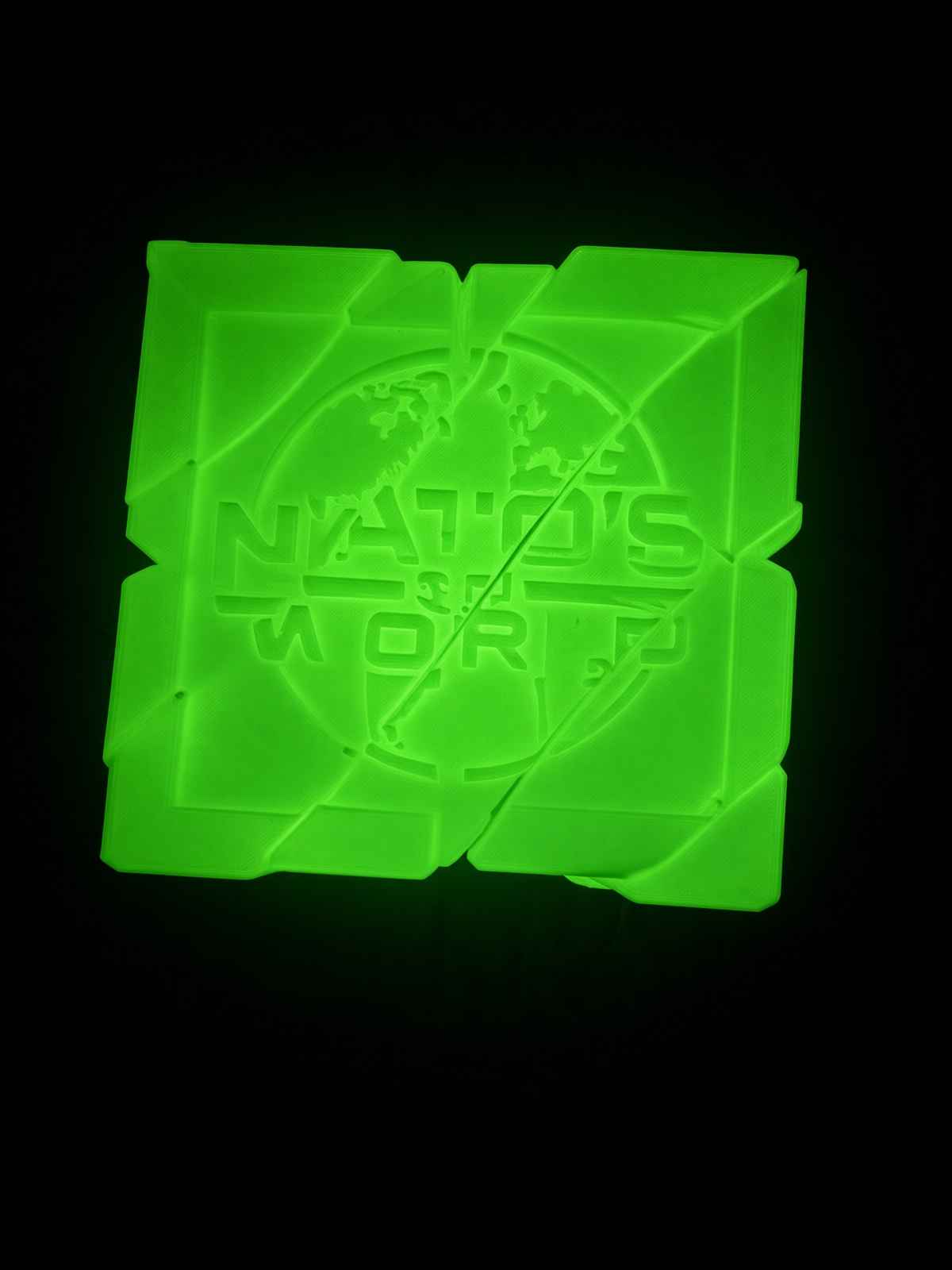 Glow green THE CUBE showing NATO’S 3D WORLD logo